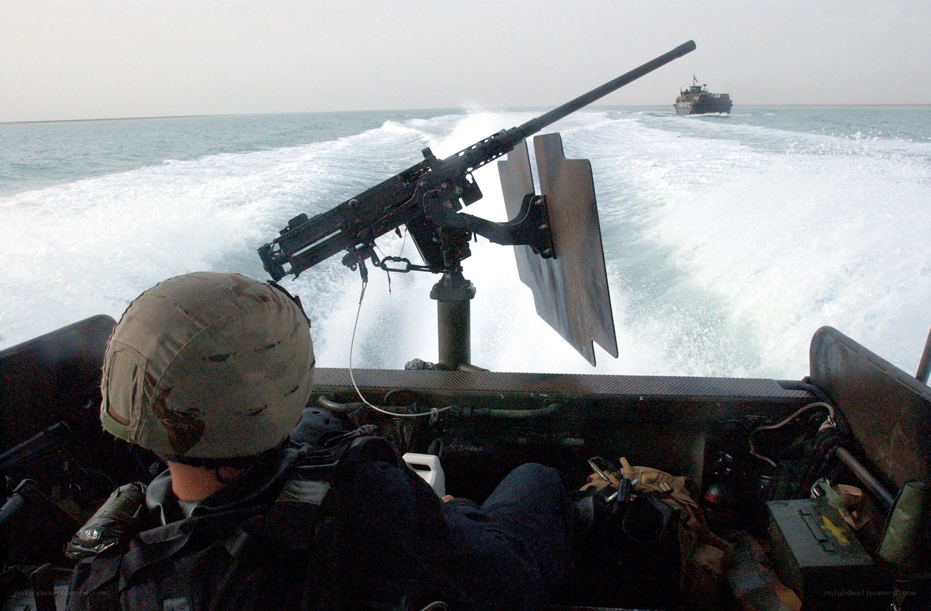 Soldier on a speedboat with machine gun