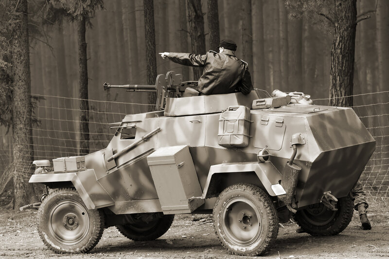 Soldier on armored vehicle in forest