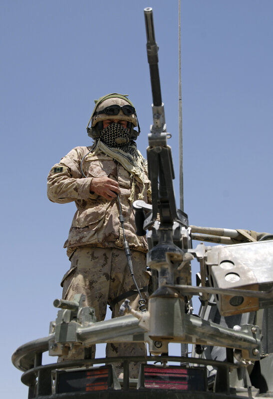 Soldier on military vehicle