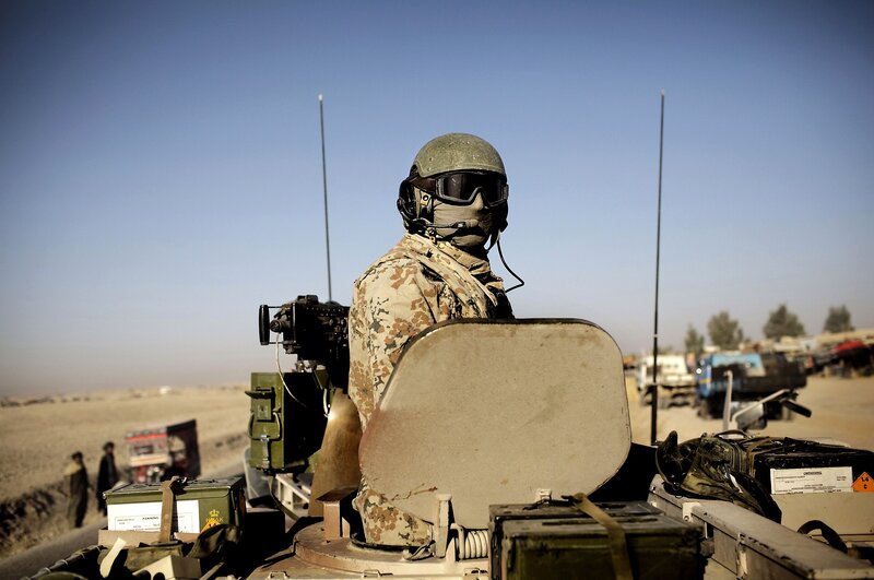Soldier on military vehicle