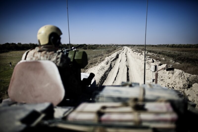 Soldier on military vehicle