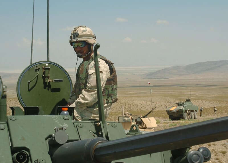 Soldier on military vehicle in desert
