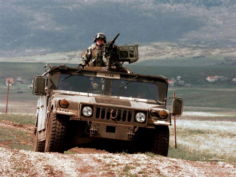 Soldier on military vehicle