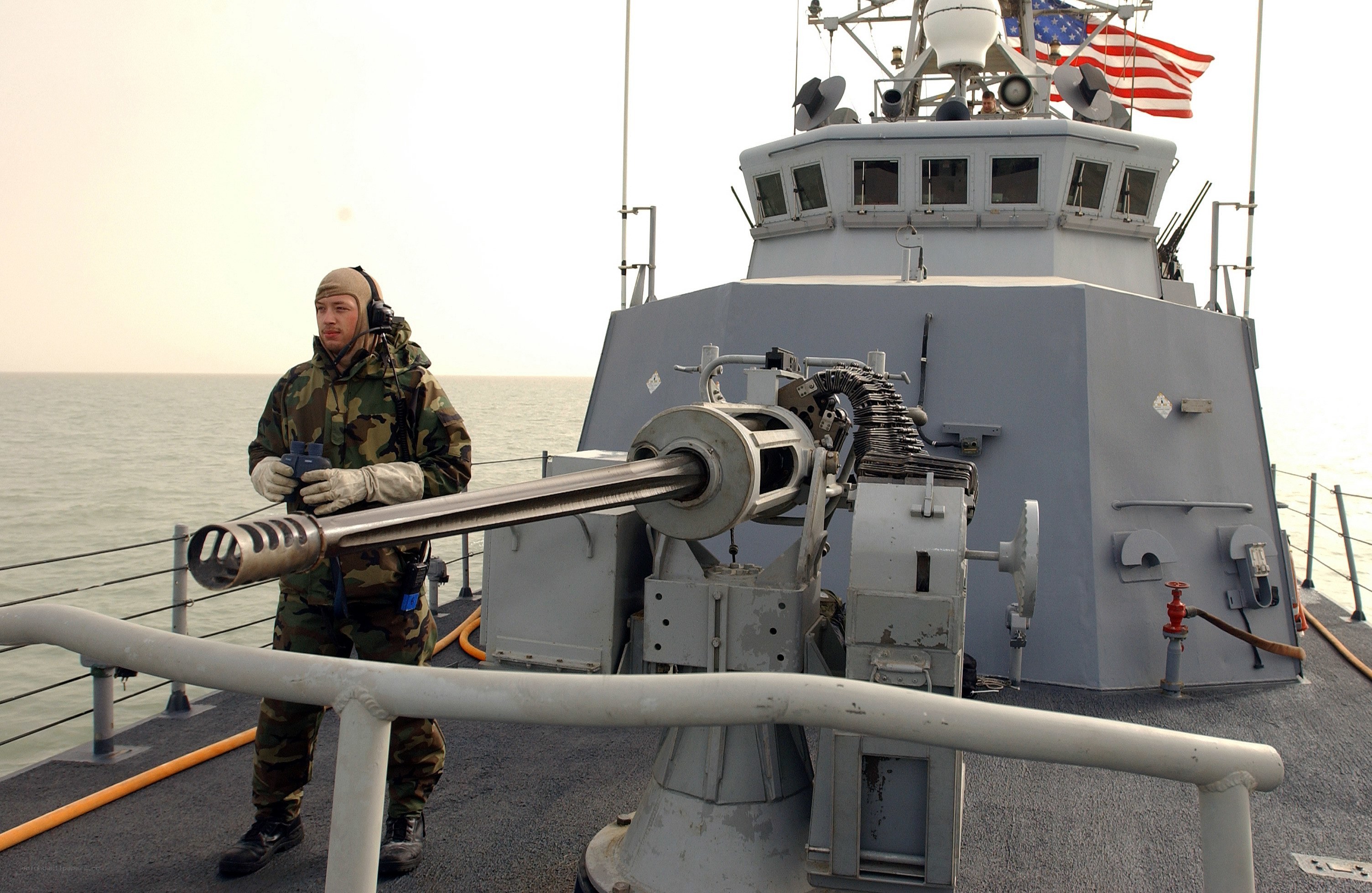 Soldier on naval vessel with weapon