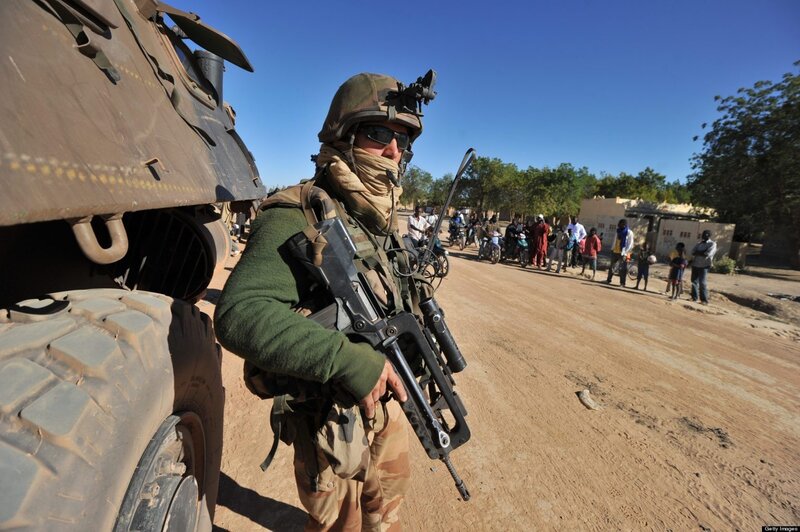 Soldier on patrol in a village