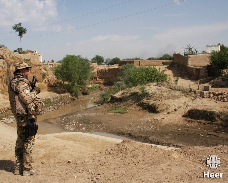Soldier on patrol in a village