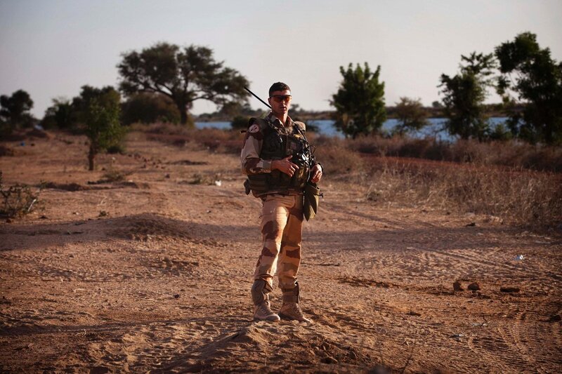 Soldier on patrol in arid landscape