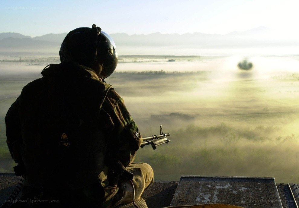 Soldier overlooking misty landscape