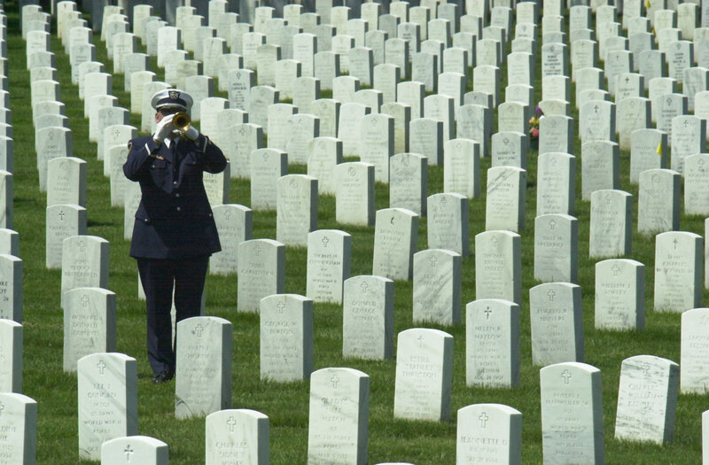 Soldier playing trumpet at cemetery