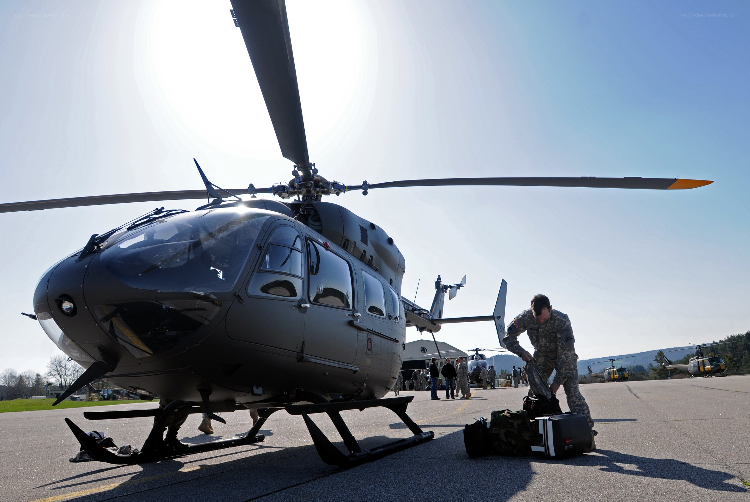 Soldier preparing gear near helicopter