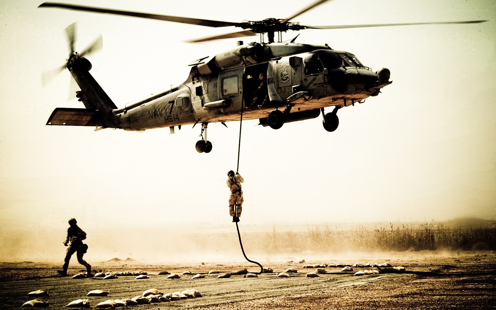 Soldier rappelling from helicopter