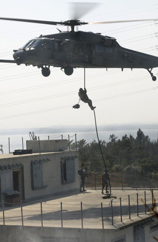 Soldier rappelling from helicopter