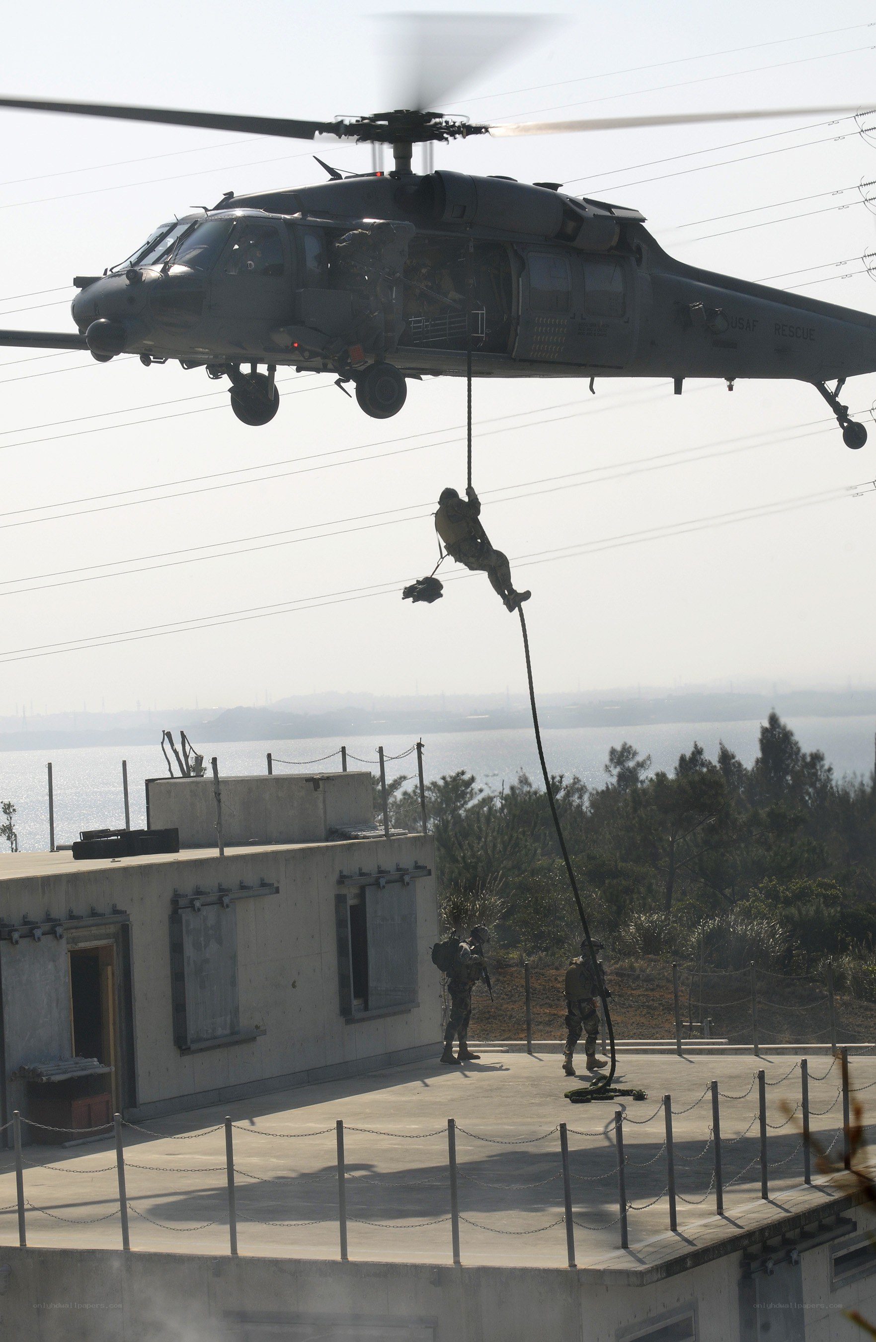 Soldier rappelling from helicopter