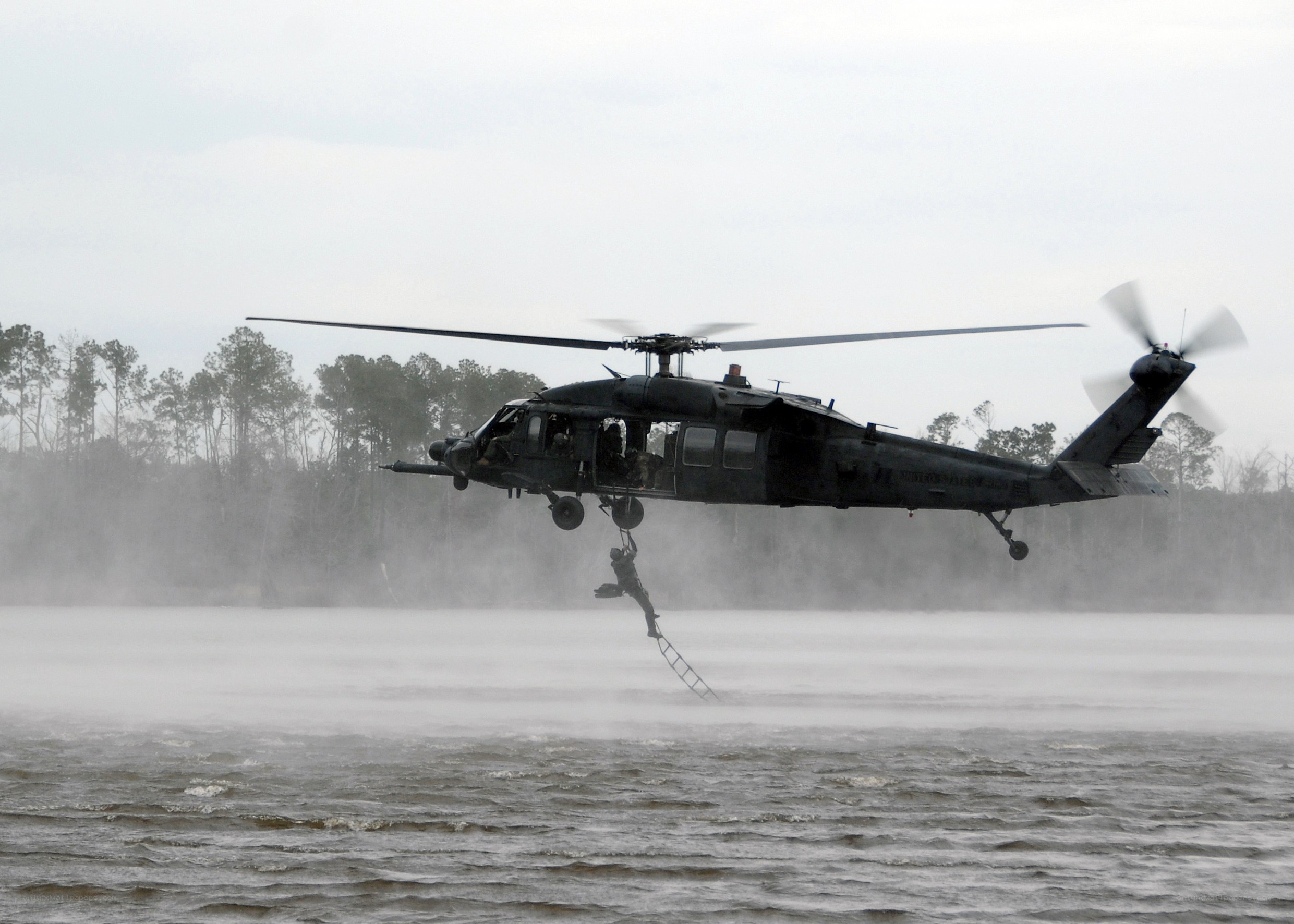 Soldier rappelling from helicopter