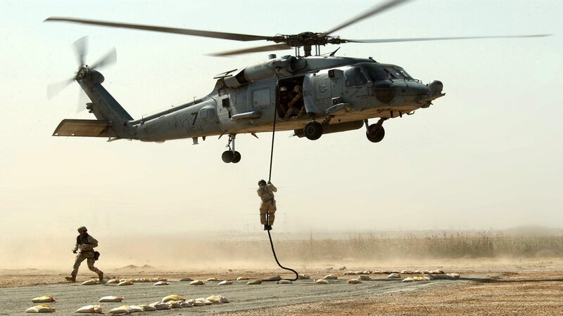 Soldier rappelling from helicopter