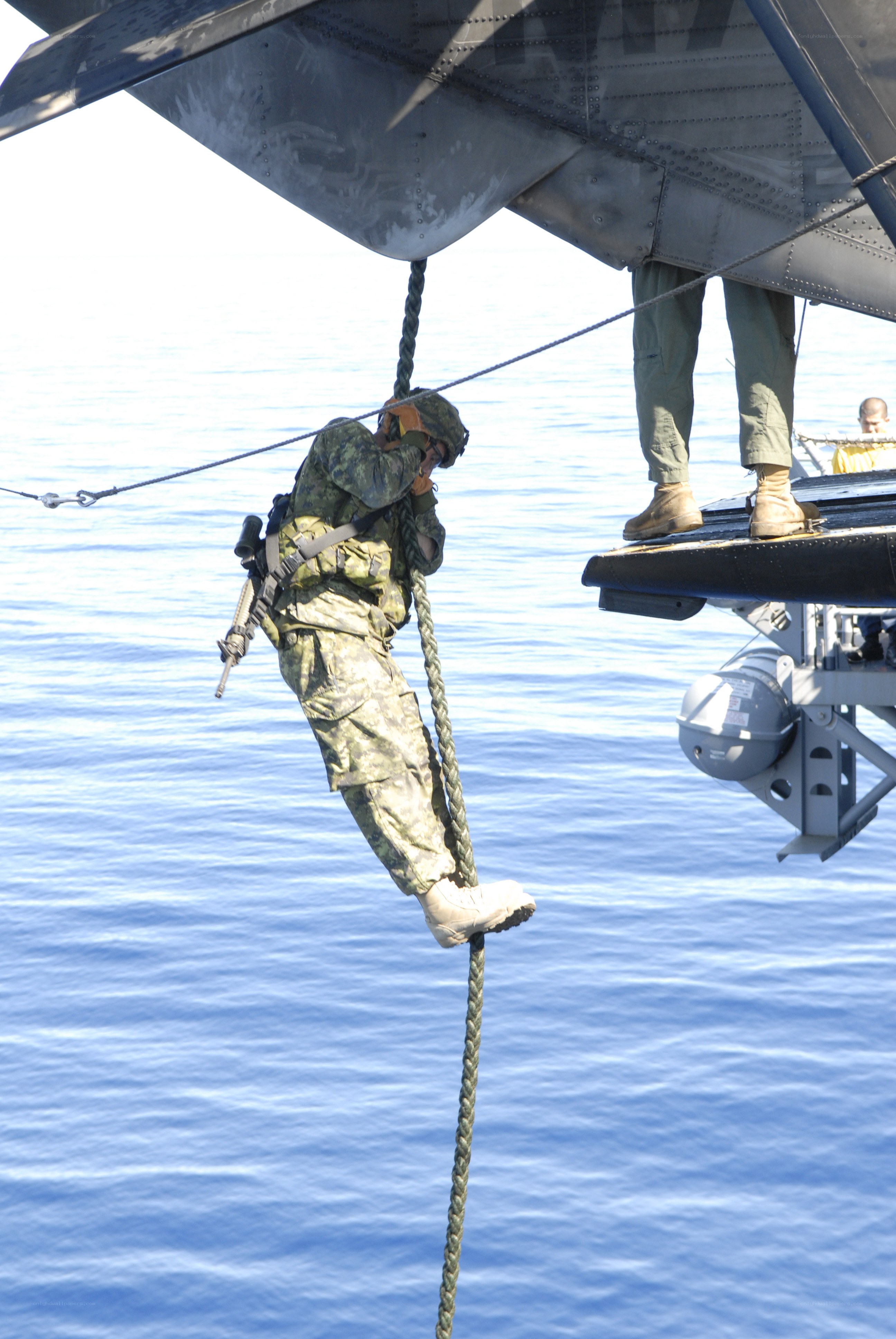 Soldier rappelling from helicopter
