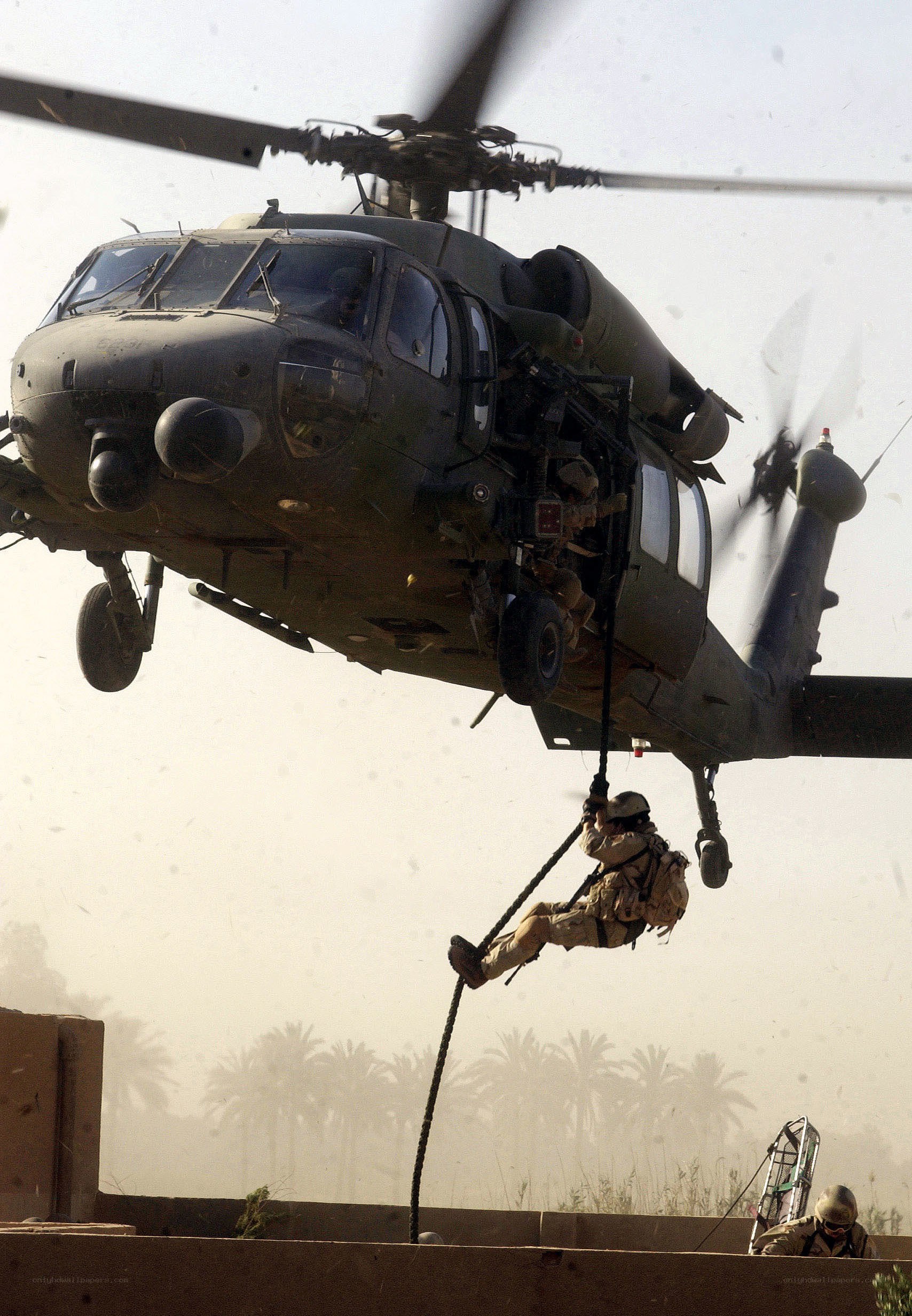 Soldier rappelling from helicopter