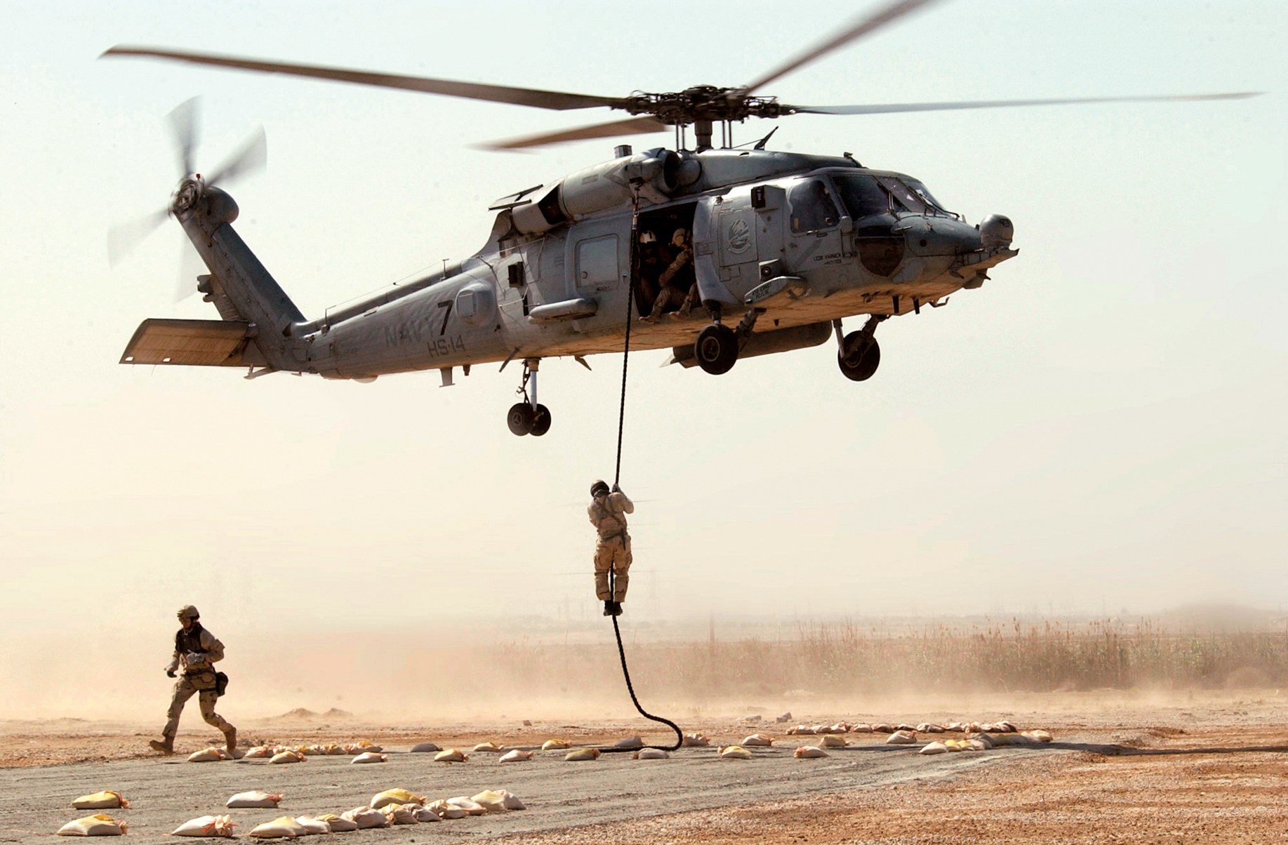 Soldier rappelling from helicopter