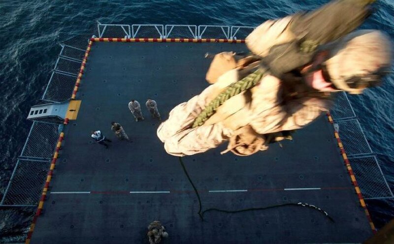 Soldier Rappelling from Ship