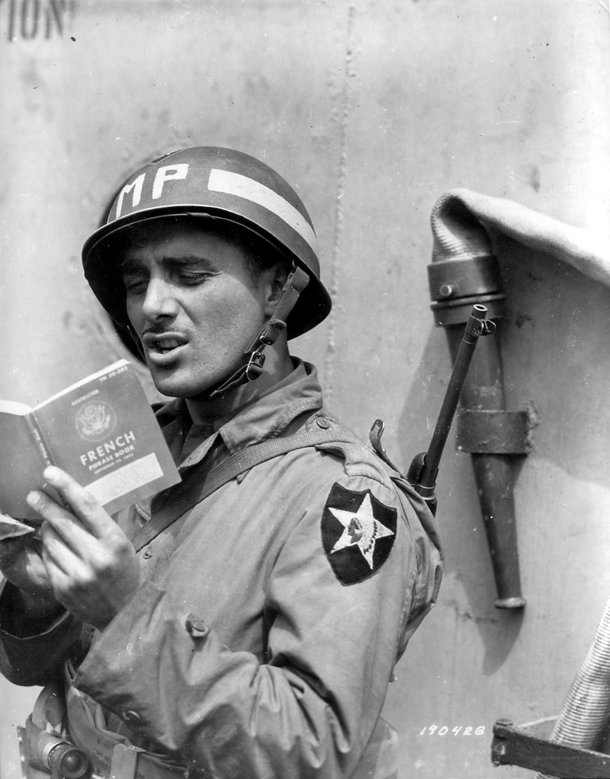 Soldier reading French phrase book
