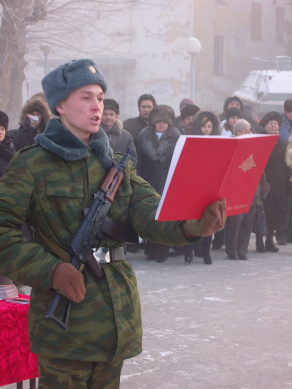 Soldier reading from a red book