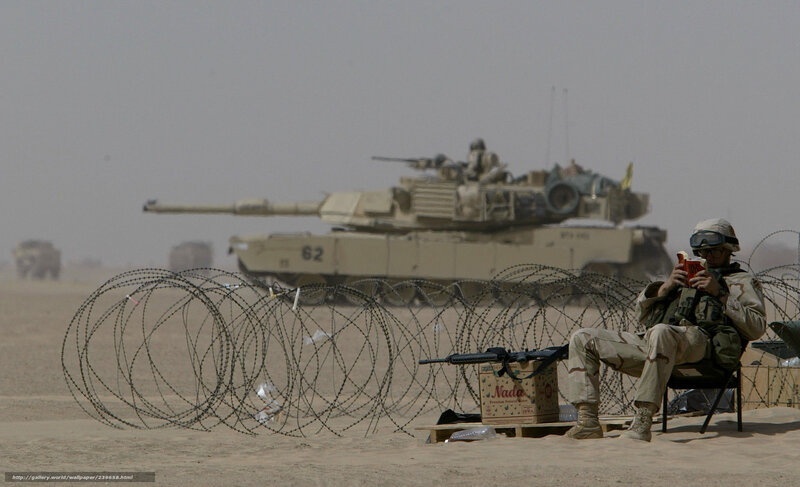 Soldier reading near tank