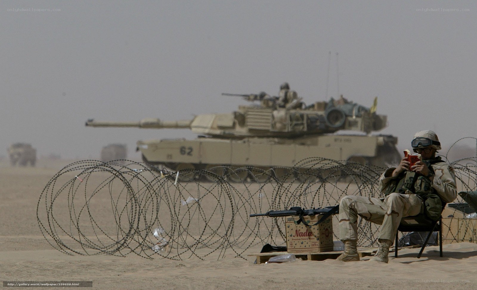 Soldier reading near tank