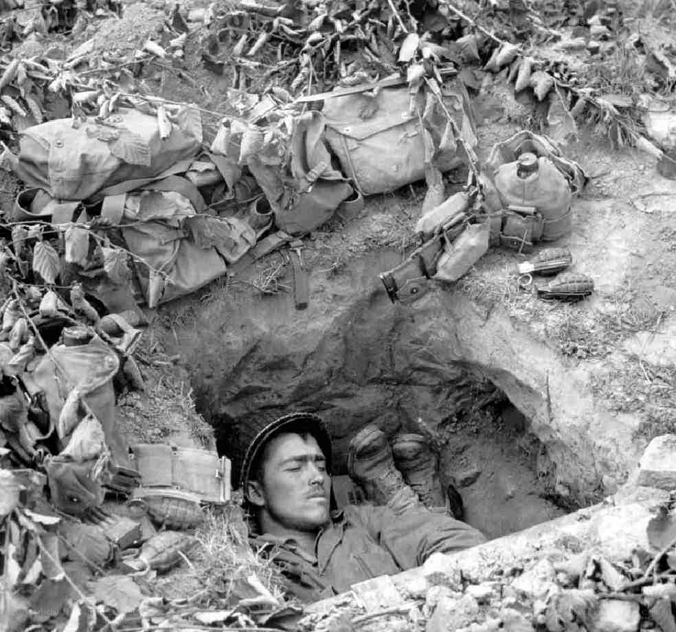 Soldier resting in trench