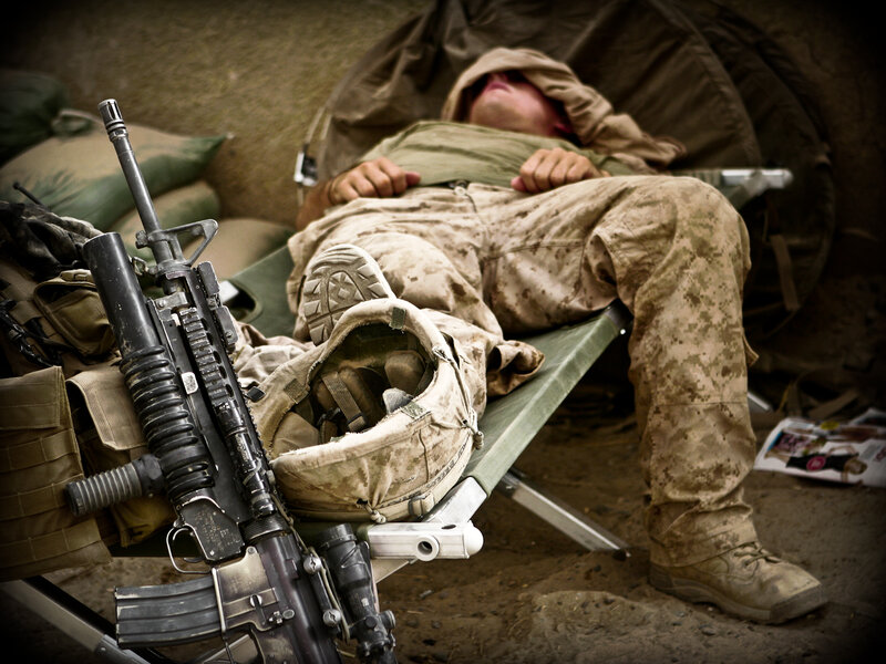 Soldier resting on a cot