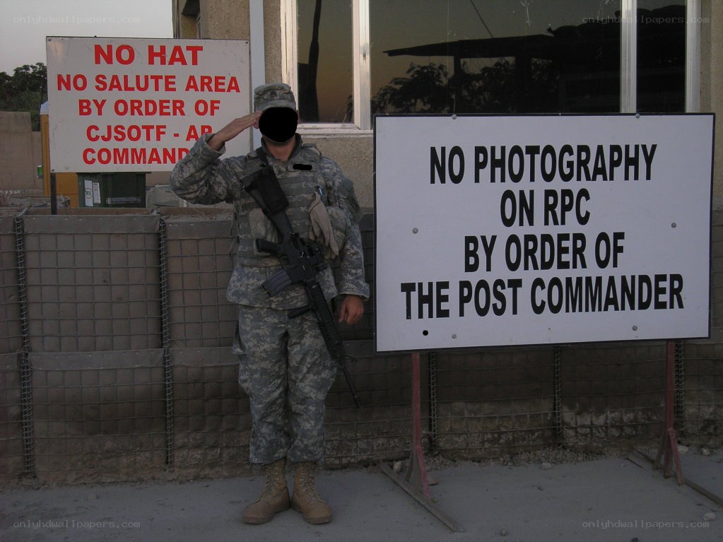 Soldier saluting near signs