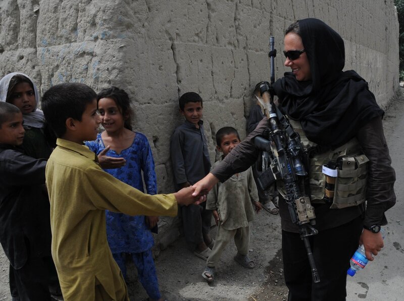 Soldier shaking hands with children