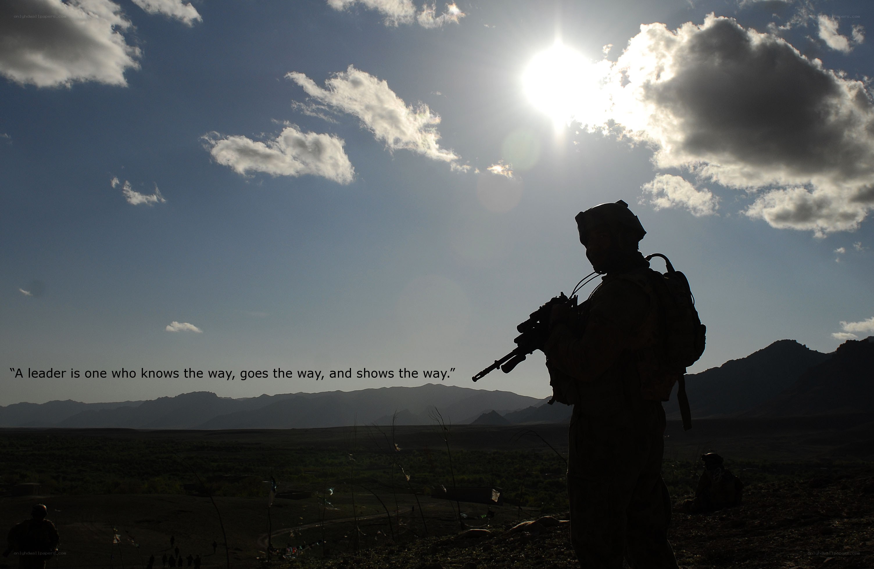 Soldier silhouetted against sun