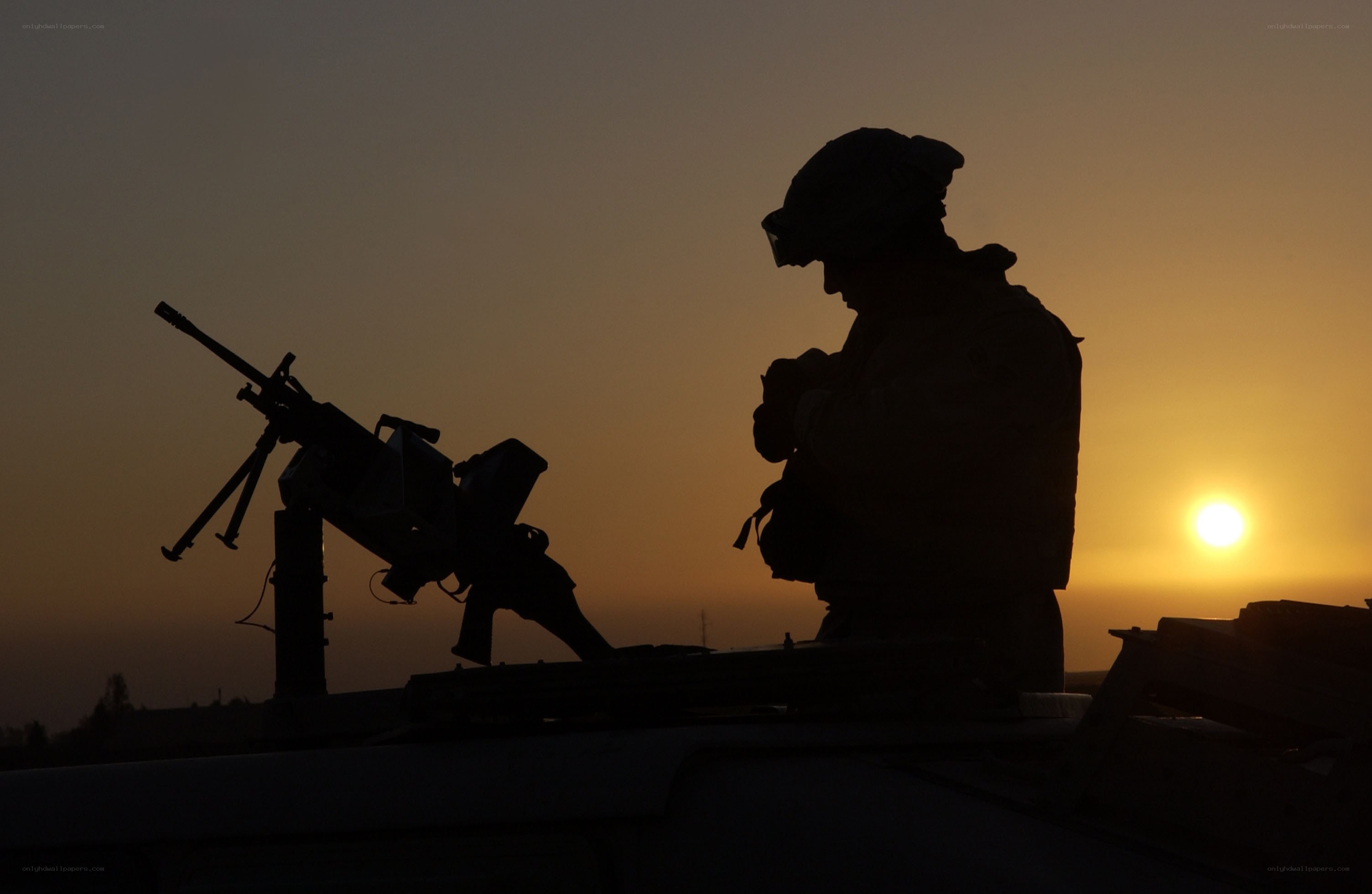 Soldier silhouetted at sunset