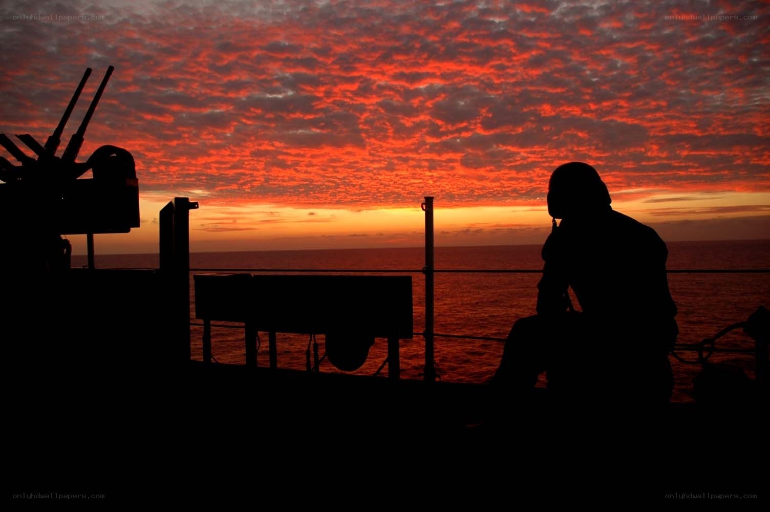 Soldier silhouetted at sunset