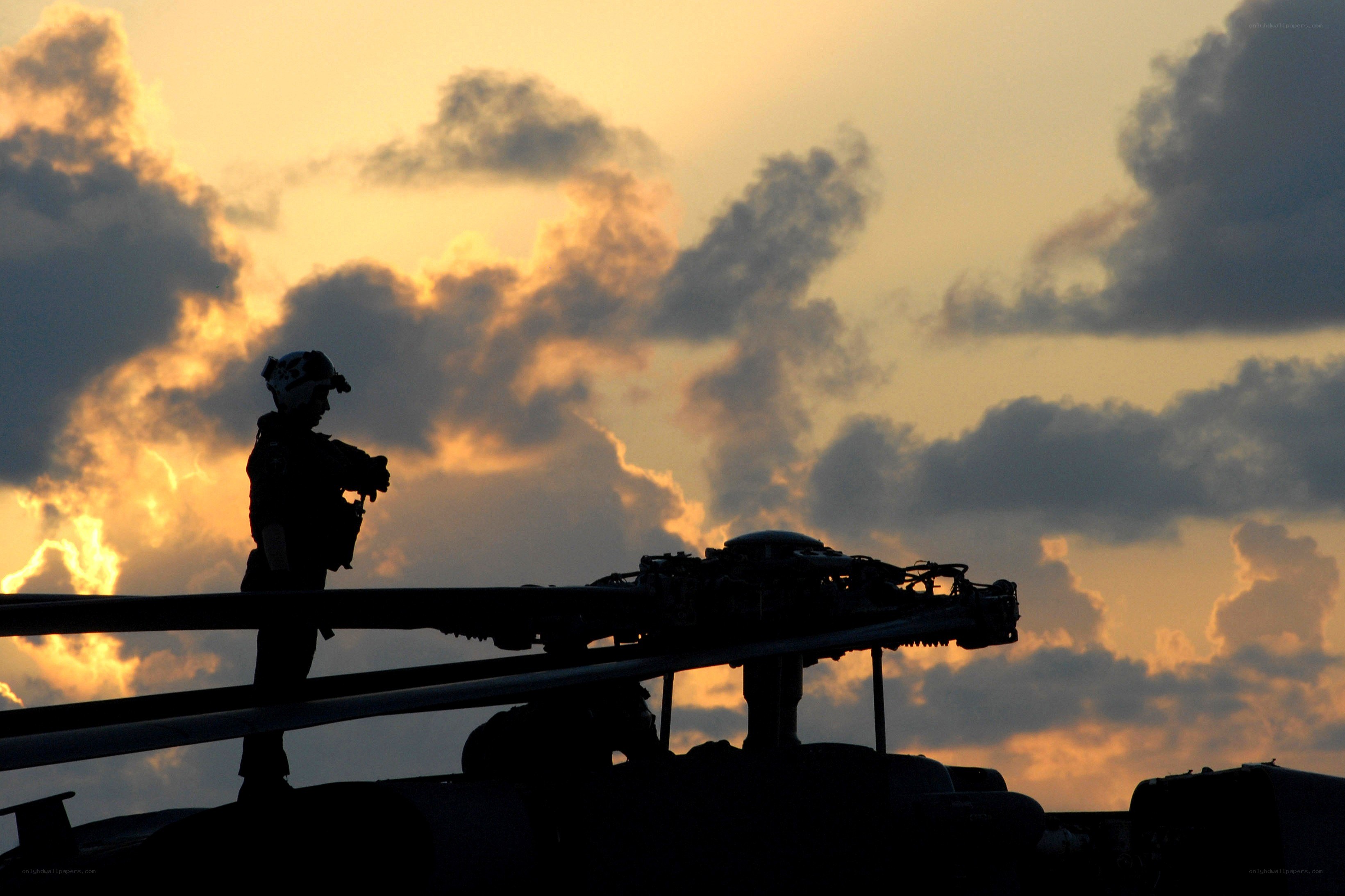 Soldier silhouetted at sunset