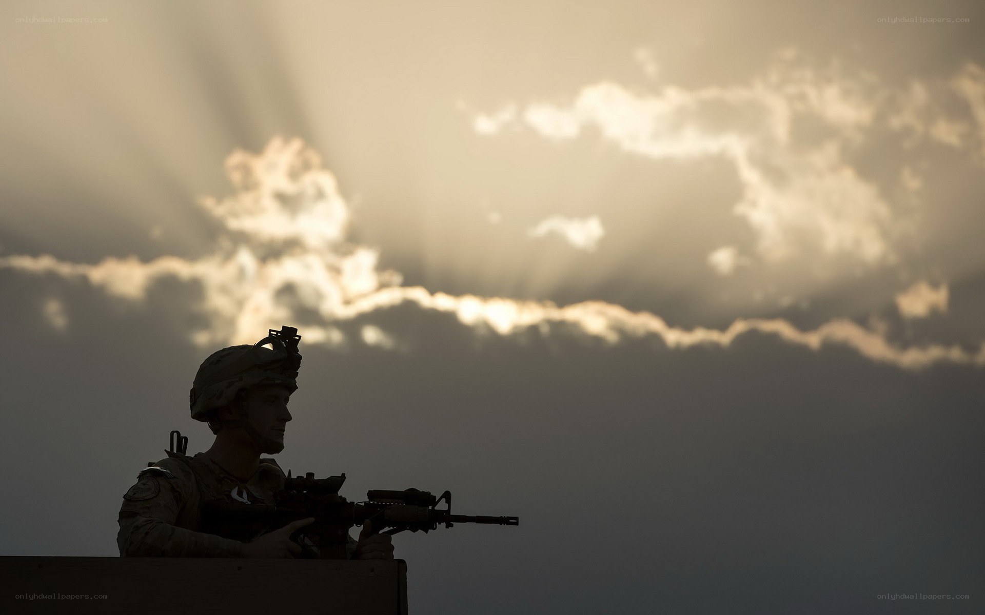 Soldier silhouetted at sunset