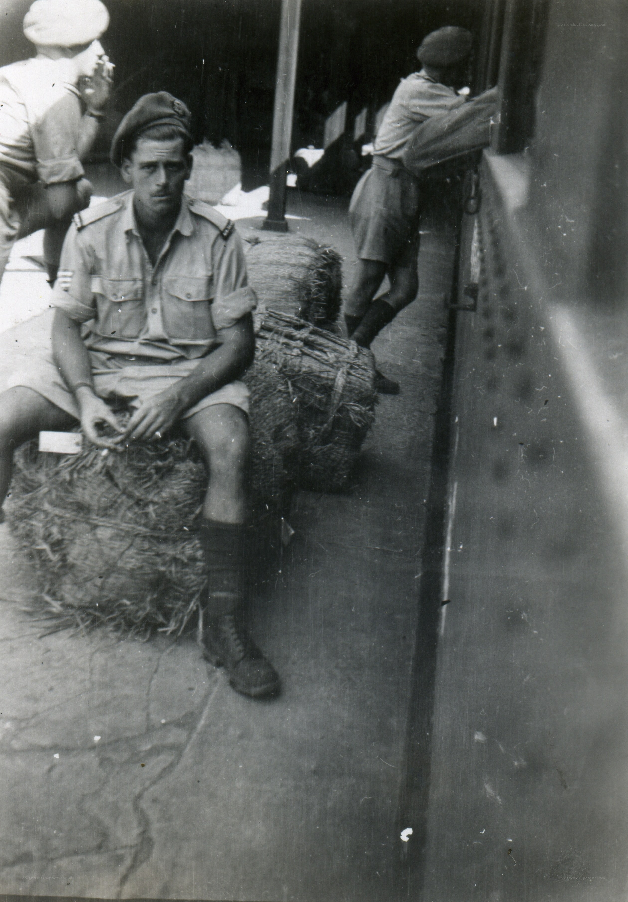 Soldier sitting on hay bale
