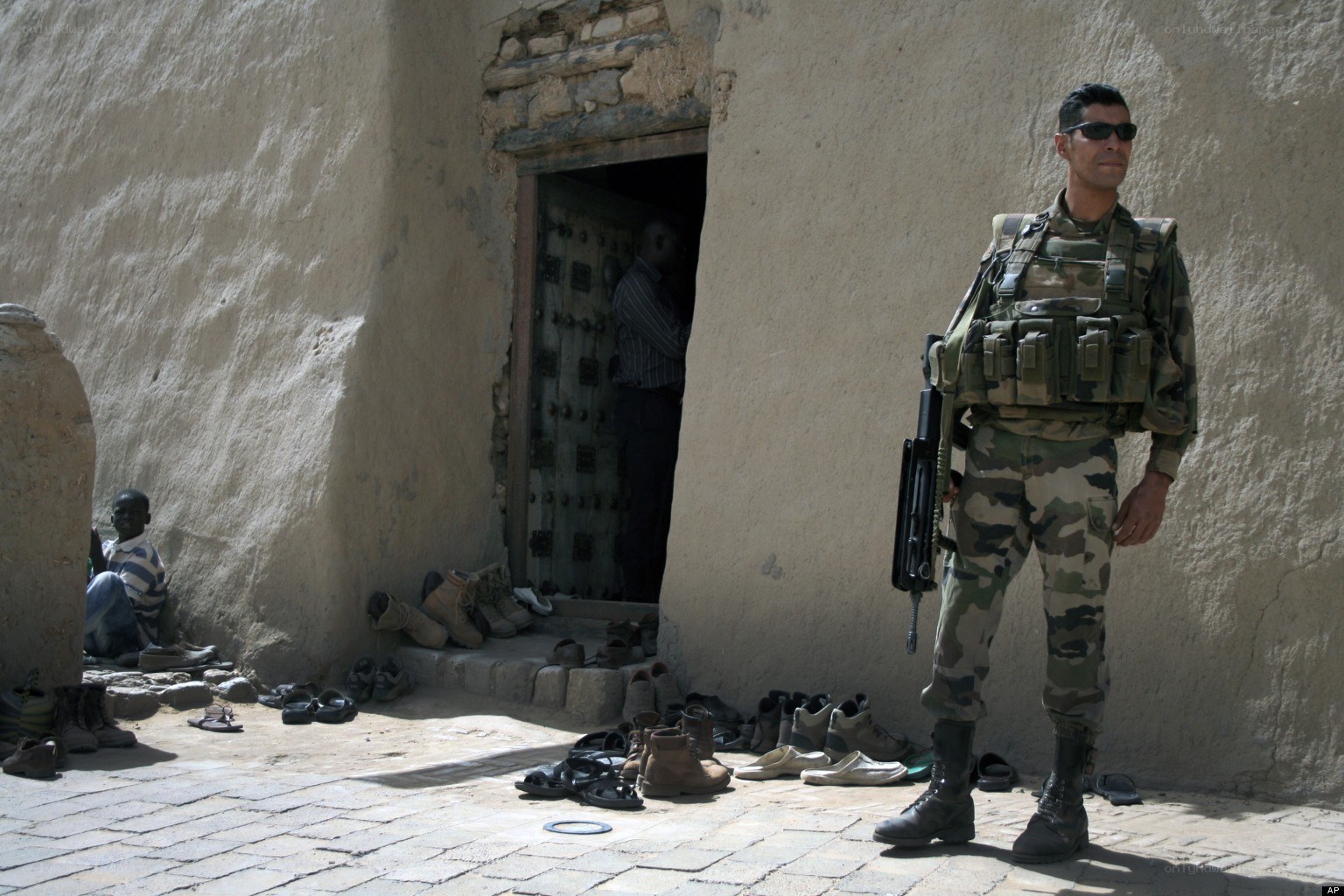 Soldier standing guard outside building
