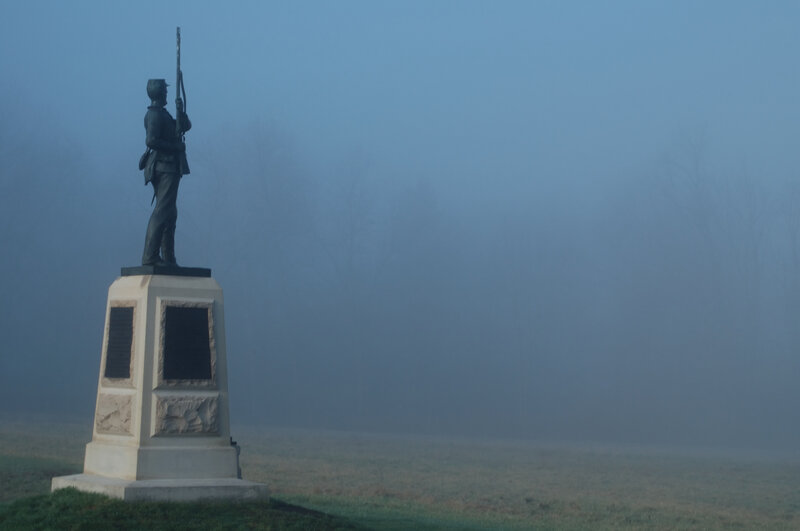 Soldier statue in foggy field