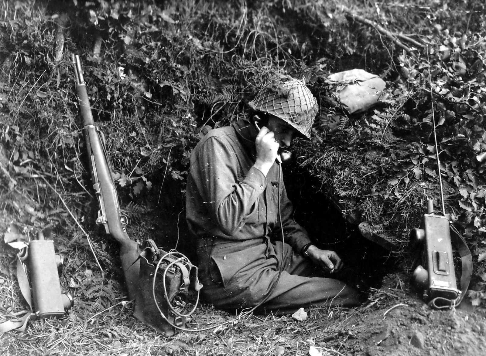 Soldier using radio in foxhole