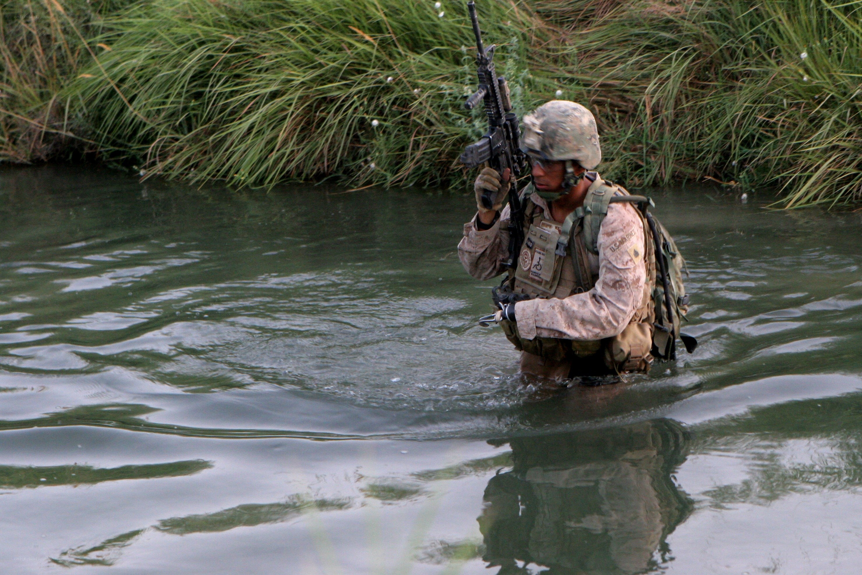 Soldier wading through water