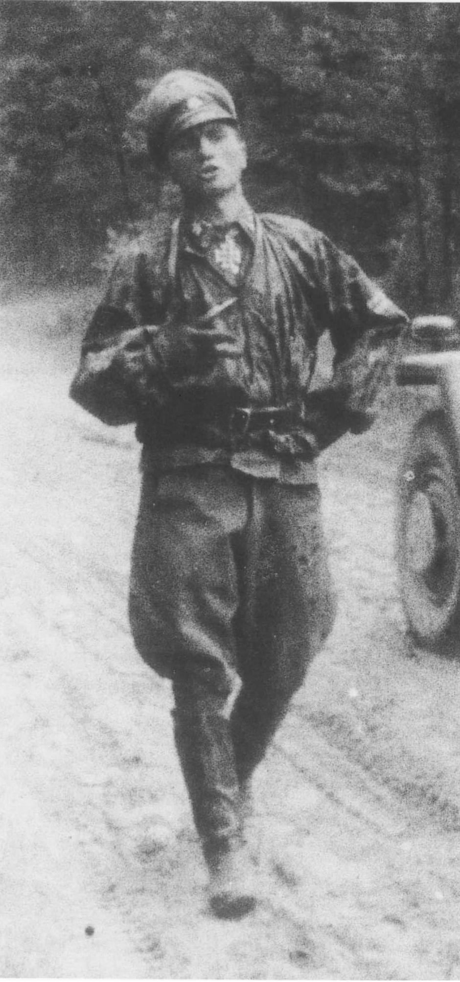 Soldier walking on a dirt road