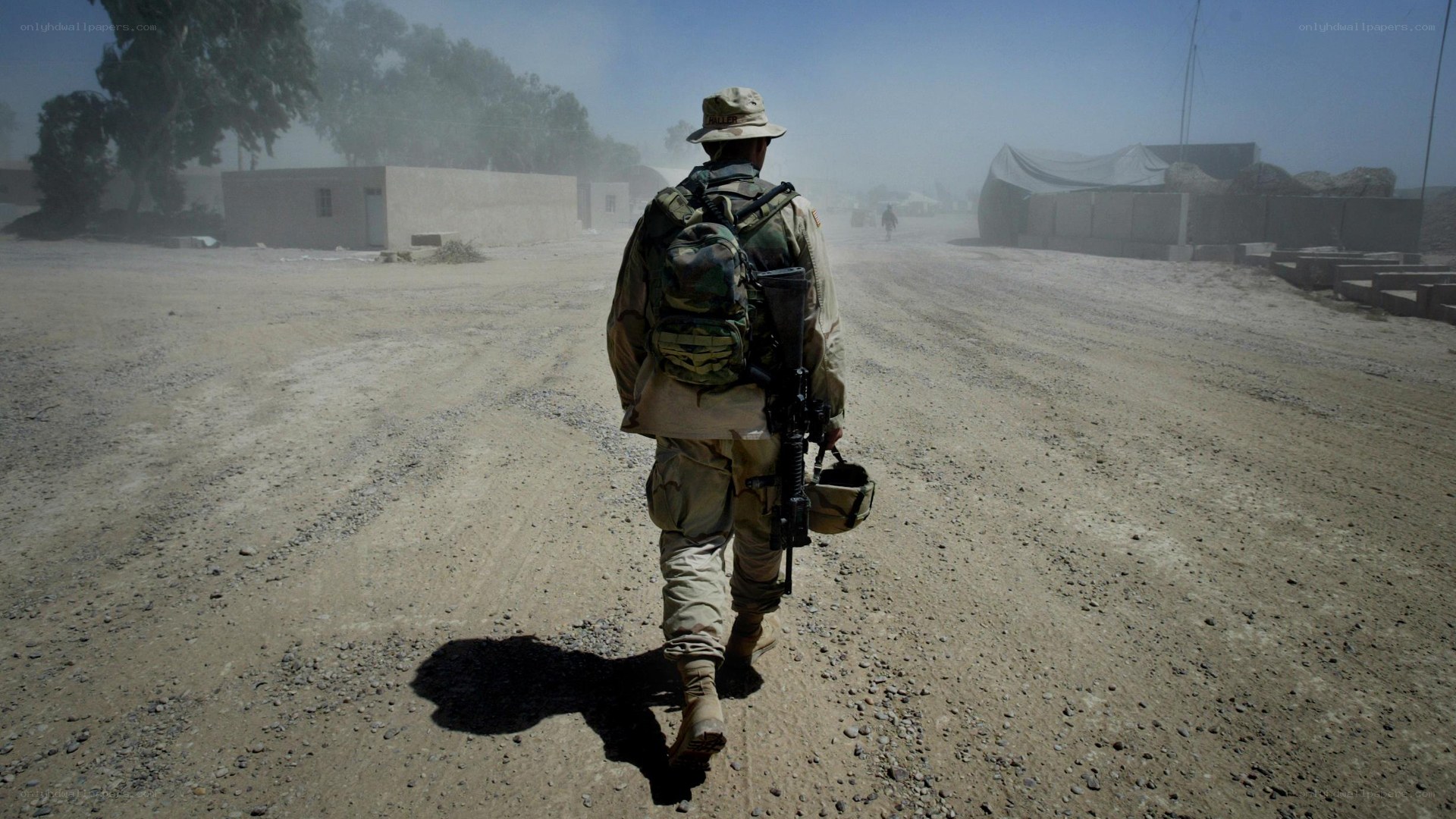 Soldier walking on a dusty road