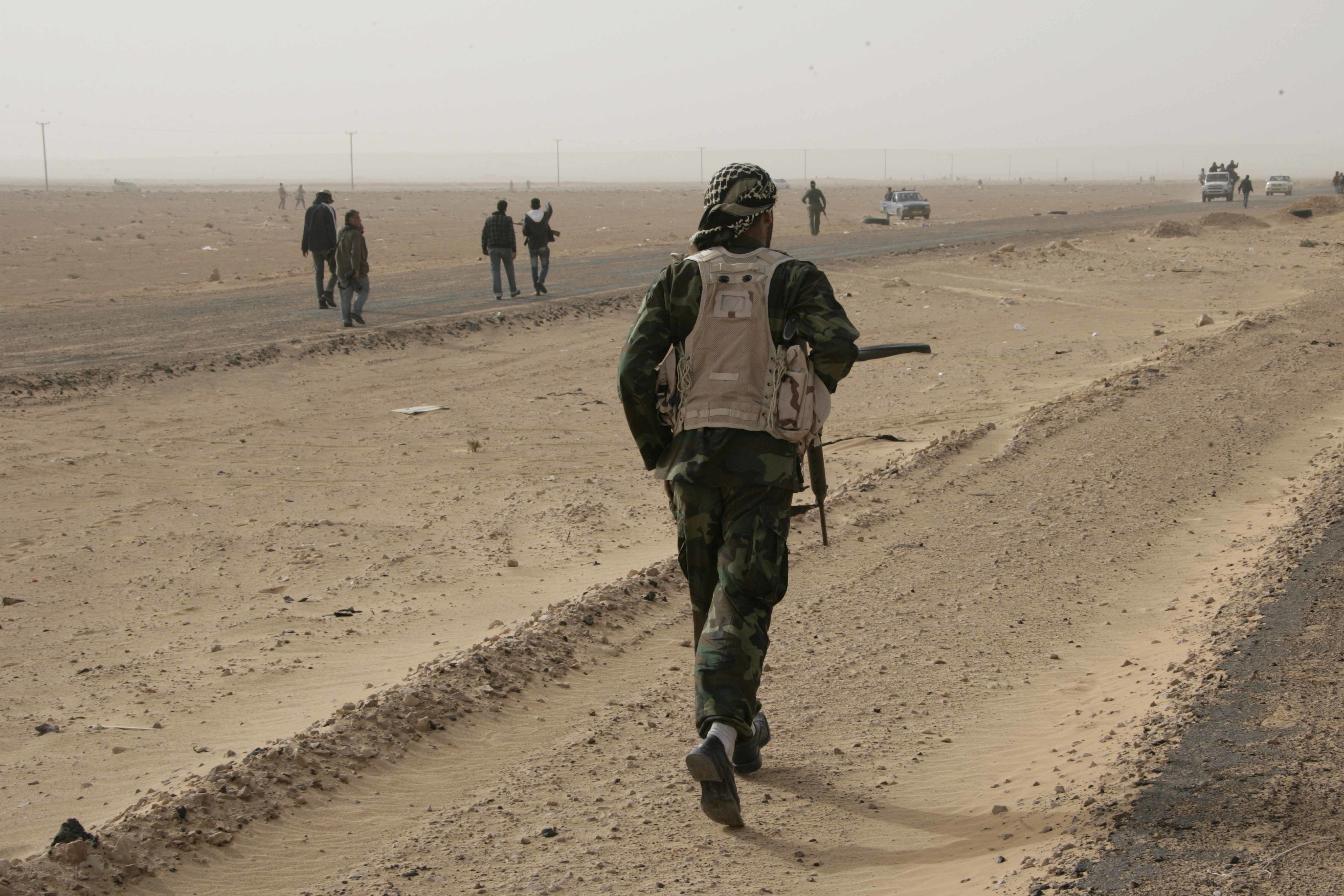 Soldier walking on desert road