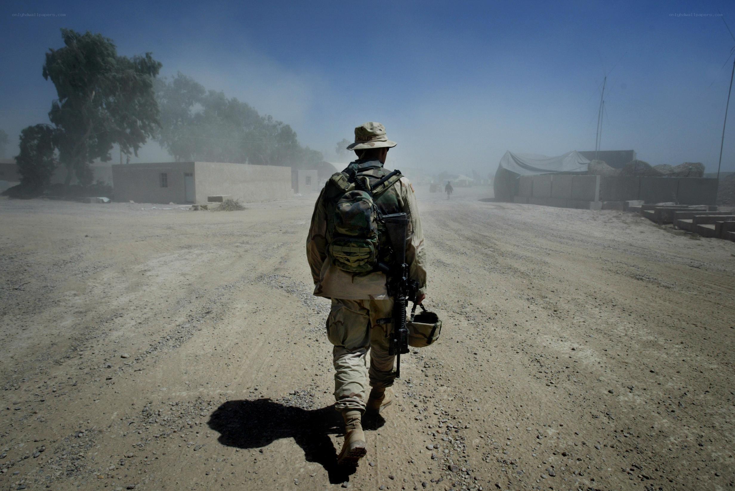 Soldier walking on dusty road