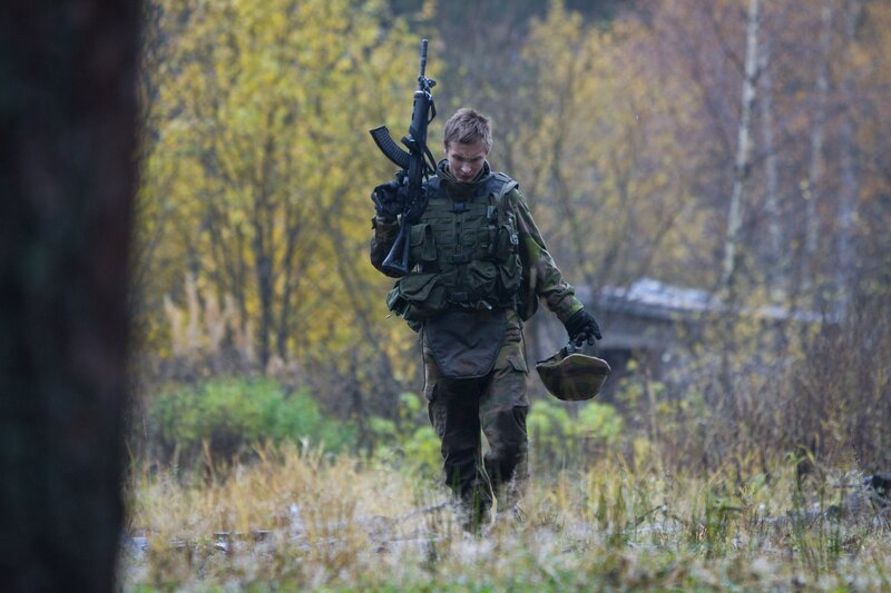 Soldier walking through forest