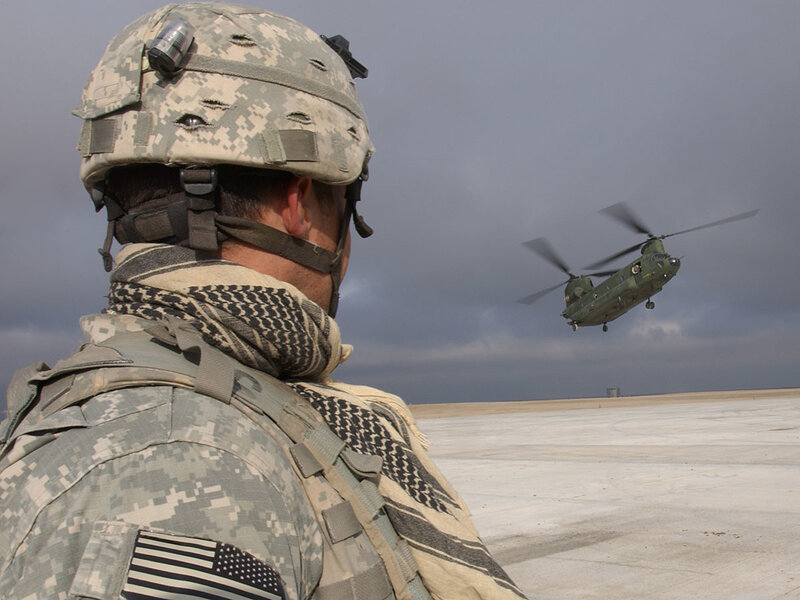 Soldier watching helicopter takeoff