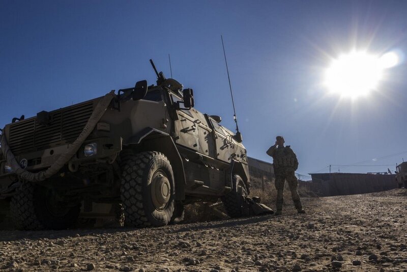Soldier with armored vehicle in desert