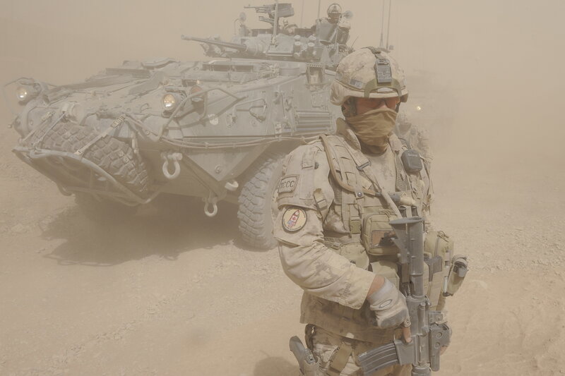 Soldier with armored vehicle in desert