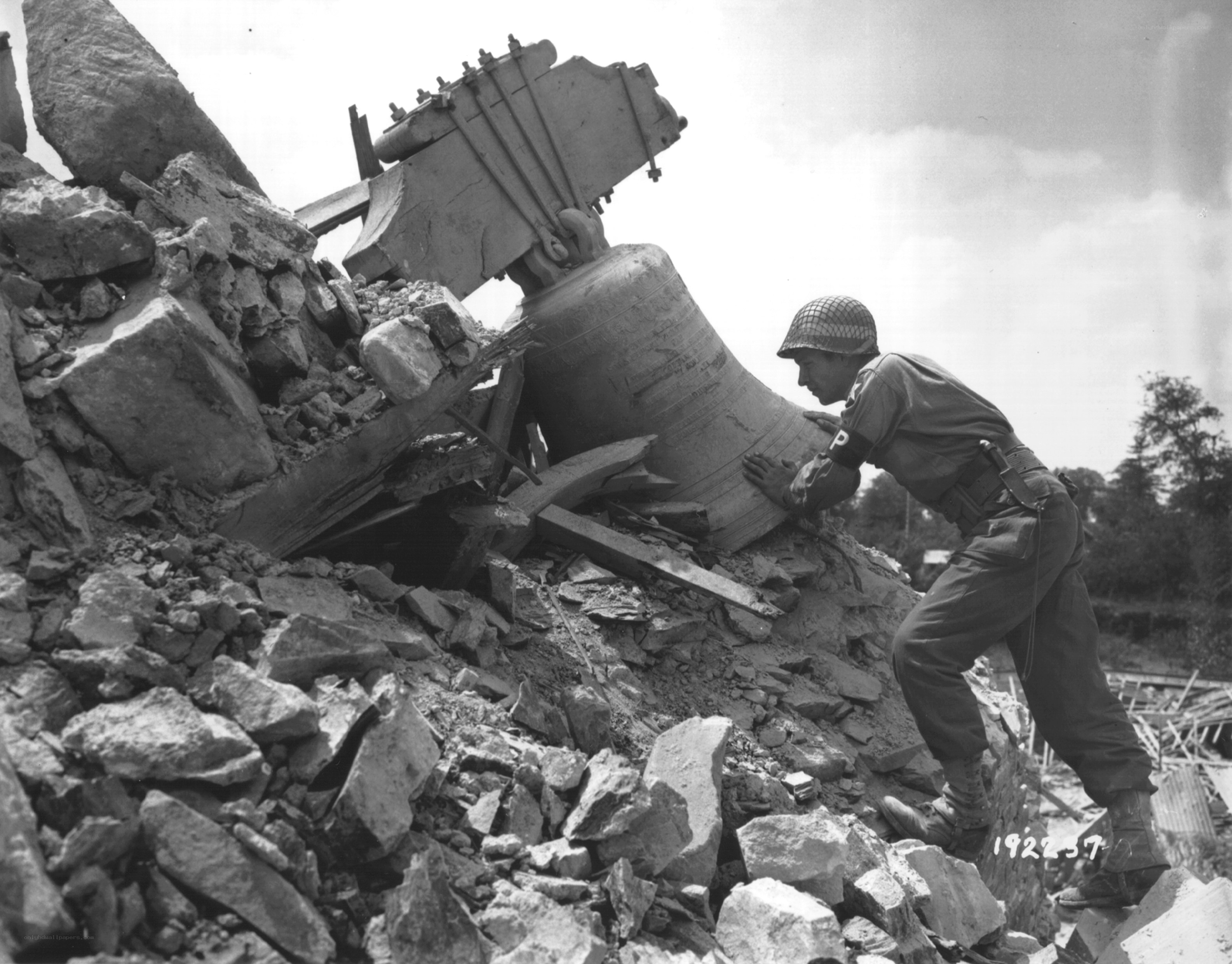Soldier with bell in rubble
